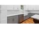 Modern kitchen with white and gray cabinets, stainless steel appliances, and a farmhouse sink at 1819 Avon Ave, Atlanta, GA 30311
