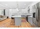 Bright kitchen with an island, stainless steel appliances, and white and grey cabinets at 1819 Avon Ave, Atlanta, GA 30311