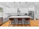 Bright, modern kitchen with white cabinets, a large island with seating, and stainless steel appliances at 1819 Avon Ave, Atlanta, GA 30311