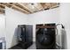 Laundry area with a new washer and dryer, offering convenience and efficiency in unfinished basement at 1819 Avon Ave, Atlanta, GA 30311