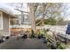 Backyard wooden deck with dining and lounge seating, flower pots, and views of the fenced yard at 592 Moreland Ne Ave, Atlanta, GA 30307