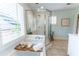 Bathroom featuring shower, tub and white tiling at 592 Moreland Ne Ave, Atlanta, GA 30307
