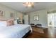 Cozy bedroom with hardwood floors, ceiling fan, and access to an ensuite bathroom at 592 Moreland Ne Ave, Atlanta, GA 30307