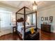 Bedroom with four poster bed frame, hardwood floors, and natural lighting at 592 Moreland Ne Ave, Atlanta, GA 30307