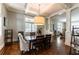Elegant dining room with hardwood floors, stylish light fixture, and open floor plan at 592 Moreland Ne Ave, Atlanta, GA 30307