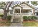 Charming home with a covered front porch, lush landscaping, and inviting curb appeal at 592 Moreland Ne Ave, Atlanta, GA 30307