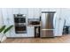 Chef's kitchen with built-in ovens, modern stainless steel refrigerator, and ample cabinet space at 592 Moreland Ne Ave, Atlanta, GA 30307