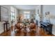 Bright living room featuring hardwood floors, fireplace, piano, and plenty of natural light at 592 Moreland Ne Ave, Atlanta, GA 30307