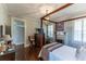 Spacious main bedroom featuring a four-poster bed, fireplace, hardwood floors, and elegant chandelier at 592 Moreland Ne Ave, Atlanta, GA 30307
