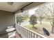 Cozy porch with white railing, table and chairs, and view of the greenery on a sunny day at 592 Moreland Ne Ave, Atlanta, GA 30307