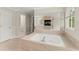 Luxurious bathroom with a soaking tub and adjacent vanities at 789 Rutland Ct, Lithonia, GA 30058