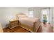 Bedroom with hardwood floors, a decorative bed frame, and natural light from two windows at 789 Rutland Ct, Lithonia, GA 30058