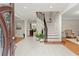 Inviting foyer features a wood staircase, tiled floors, and views into the formal rooms at 789 Rutland Ct, Lithonia, GA 30058