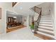 Foyer with tile floor leads to formal dining room and a staircase with iron balusters at 789 Rutland Ct, Lithonia, GA 30058