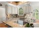 Bright kitchen with granite countertops, stainless steel appliances, and arched windows at 789 Rutland Ct, Lithonia, GA 30058