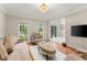Bright living room with large windows, hardwood floors, and ample natural light at 789 Rutland Ct, Lithonia, GA 30058