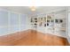 Bright living room featuring hardwood floors and custom built-in shelving at 789 Rutland Ct, Lithonia, GA 30058