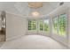 Bright sitting area featuring walls of windows and lush greenery at 789 Rutland Ct, Lithonia, GA 30058