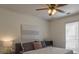 This bedroom features a ceiling fan, white comforter, and large bright windows at 2260 Golden Valley Dr, Lawrenceville, GA 30043