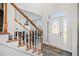 Inviting home foyer featuring stairs, an elegant front door, and luxury vinyl plank flooring at 2543 Oak Creek Ln, Conyers, GA 30094