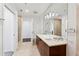 This primary bathroom features double sinks, a stand alone glass shower, and modern finishes at 3325 Piedmont Ne Rd # 1504, Atlanta, GA 30305