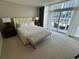 Bright bedroom with large windows and a seating area overlooking an outdoor patio at 3325 Piedmont Ne Rd # 1504, Atlanta, GA 30305