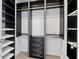 Walk-in closet with custom shelving and drawers for optimal storage solutions at 3325 Piedmont Ne Rd # 1504, Atlanta, GA 30305
