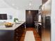 Modern kitchen with stainless steel appliances, center island and dark wood cabinetry at 3325 Piedmont Ne Rd # 1504, Atlanta, GA 30305