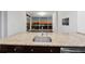 Modern kitchen with granite countertop island and sink overlooking city view at 3325 Piedmont Ne Rd # 1504, Atlanta, GA 30305