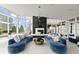 Modern living room boasts curved blue sofas, a marble fireplace, and expansive windows with city views at 3325 Piedmont Ne Rd # 1504, Atlanta, GA 30305