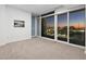 Open living room with large windows, city views and sliding door access to a balcony at 3325 Piedmont Ne Rd # 1504, Atlanta, GA 30305