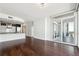Open living space with hardwood floors and a balcony overlooking the city at 3325 Piedmont Ne Rd # 1504, Atlanta, GA 30305