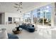 Bright living room has floor-to-ceiling windows with skyline view and a large blue sofa at 3325 Piedmont Ne Rd # 1504, Atlanta, GA 30305