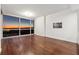 Spacious living room featuring hardwood floors and large windows with stunning city views at 3325 Piedmont Ne Rd # 1504, Atlanta, GA 30305