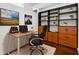 Home office with built-in shelving and modern decor, with a spacious desk and comfortable chair at 3325 Piedmont Ne Rd # 1504, Atlanta, GA 30305