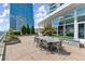 Outdoor dining area on a rooftop featuring a large wooden table, chairs, and stunning city views at 3325 Piedmont Ne Rd # 1504, Atlanta, GA 30305