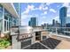 A stunning outdoor kitchen on a rooftop with a stainless steel grill and amazing city views at 3325 Piedmont Ne Rd # 1504, Atlanta, GA 30305