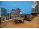 Enjoy dinner with a view on this patio featuring a built-in outdoor kitchen and dining space at 3325 Piedmont Ne Rd # 1504, Atlanta, GA 30305