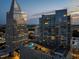 A high angle captures the building at dusk and rooftop amenity deck with pool and seating at 3325 Piedmont Ne Rd # 1504, Atlanta, GA 30305