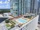 Stunning rooftop pool and amenity deck featuring lounge chairs, dining, green space, and covered seating at 3325 Piedmont Ne Rd # 1504, Atlanta, GA 30305