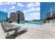Rooftop swimming pool surrounded by lounge chairs, providing a luxurious and relaxing outdoor experience at 3325 Piedmont Ne Rd # 1504, Atlanta, GA 30305