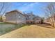 View of the home's deck and brick foundation from a large backyard at 426 Lanesborough Dr, Marietta, GA 30064