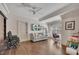 Comfortable bonus room features hardwood floors, ceiling fan, sofa and a mounted television at 426 Lanesborough Dr, Marietta, GA 30064