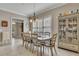 Bright dining area with a large table, decorative cabinet, and natural light, perfect for Gathering meals and entertaining at 426 Lanesborough Dr, Marietta, GA 30064