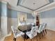 Elegant dining room with wainscoting, designer lighting, and ample natural light at 426 Lanesborough Dr, Marietta, GA 30064