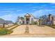 Beautiful two-story home featuring a grand entrance, arched windows, and meticulously maintained landscaping at 426 Lanesborough Dr, Marietta, GA 30064
