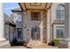 Close-up of the brick facade and front door with decorative ironwork and sconces at 426 Lanesborough Dr, Marietta, GA 30064