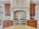 Gourmet kitchen featuring a professional-grade stove, custom range hood, and elegant cabinetry at 426 Lanesborough Dr, Marietta, GA 30064