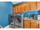 Functional laundry room featuring a modern washer and dryer and built-in oak cabinets at 426 Lanesborough Dr, Marietta, GA 30064