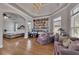 Bright living room featuring a tray ceiling, hardwood floors, and walls with a seating area and exercise equipment at 426 Lanesborough Dr, Marietta, GA 30064